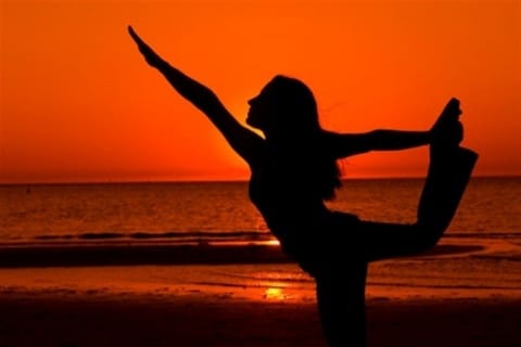 woman yoga on beach sunset Medium