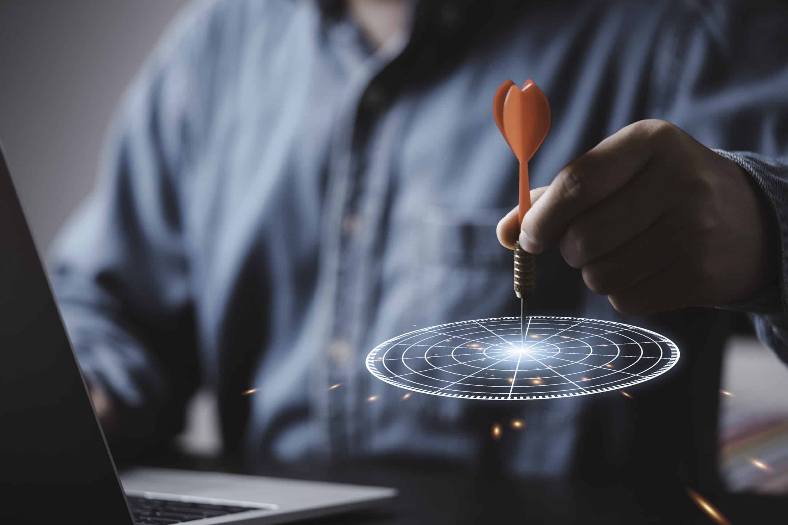 Businessman throwing red arrow dart to virtual target dart board